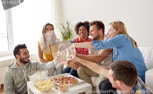 Image of friends having party and clinking drinks at home