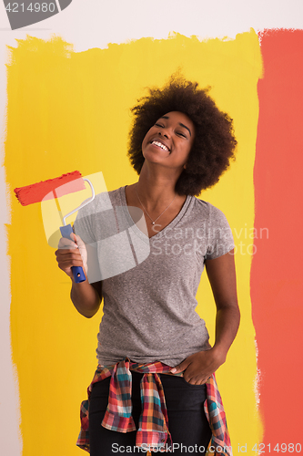 Image of black woman painting wall