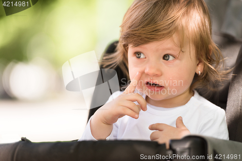 Image of baby girl sitting in the pram