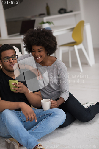 Image of African American couple relaxing in new house