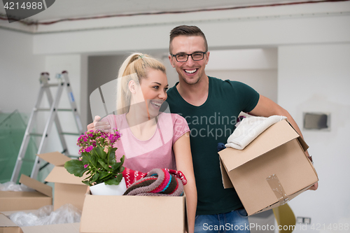 Image of young couple moving into a new home