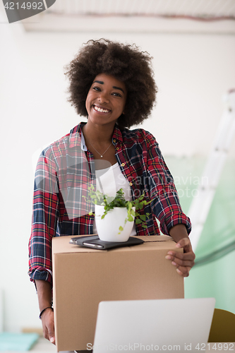 Image of Black girl moving in the new apartment
