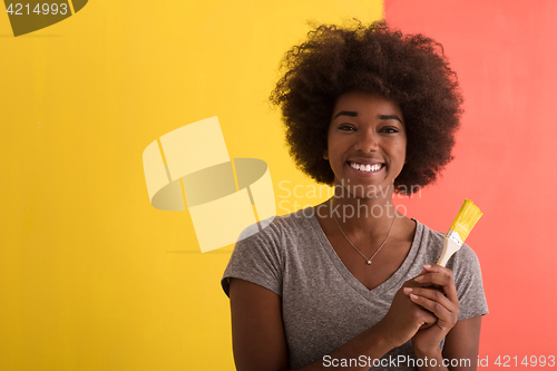 Image of black woman painting wall