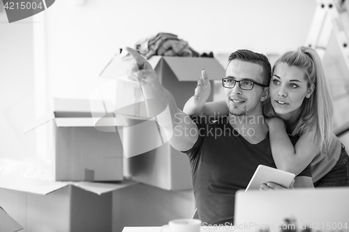 Image of Young couple moving in a new home