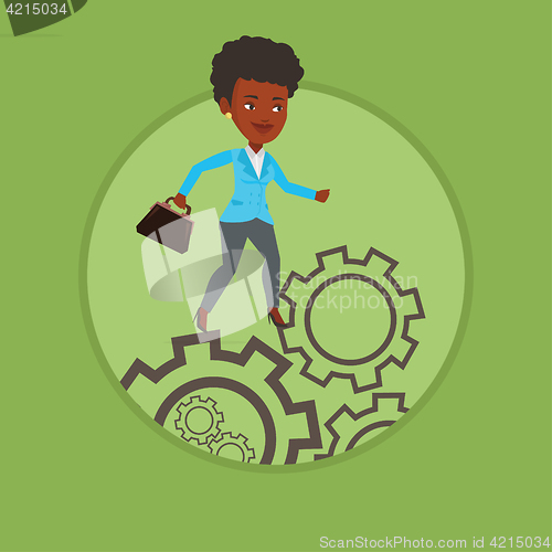 Image of Business woman running on cogwheels.