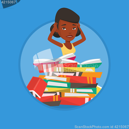 Image of Student sitting in huge pile of books.