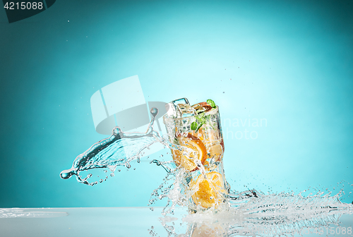 Image of The rose exotic cocktail and fruit on blue