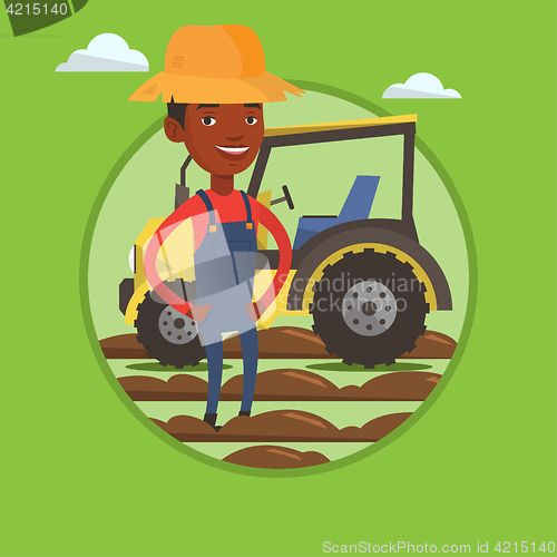 Image of Farmer standing with tractor on background.