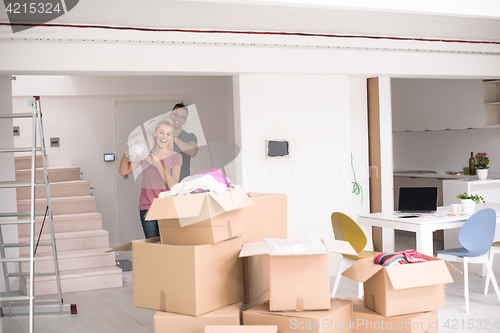 Image of couple carrying a carpet moving in to new home