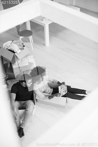 Image of African American couple  playing with packing material