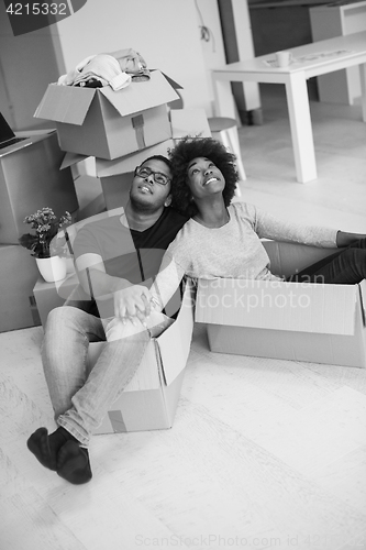 Image of African American couple  playing with packing material