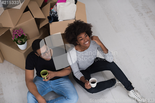 Image of African American couple relaxing in new house