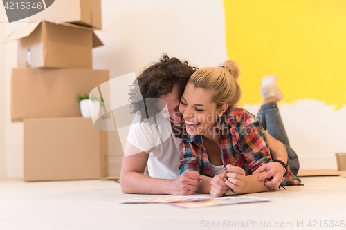 Image of Happy young couple relaxing after painting