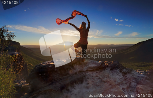 Image of Woman Pilates Yoga balance  with sheer flowing fabric