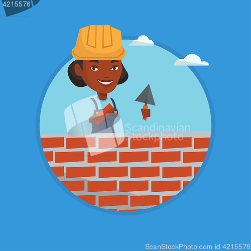 Image of Bricklayer working with spatula and brick.