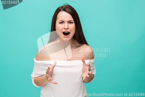 Image of Frustrated young woman posing on blue