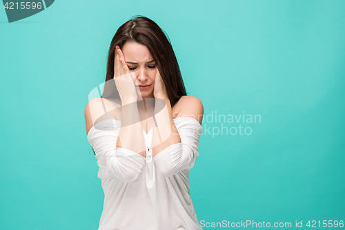 Image of Frustrated young woman posing on blue