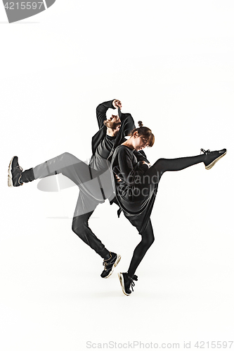 Image of The silhouettes of two hip hop male and female break dancers dancing on white background