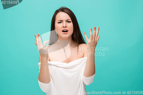 Image of Frustrated young woman posing on blue