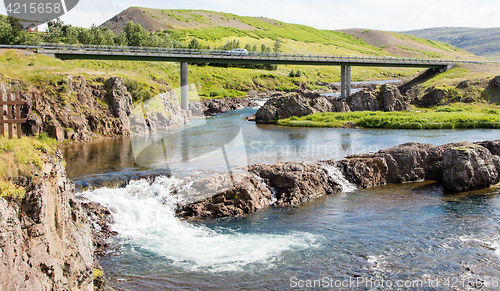 Image of Bridge over a small river and the car on it