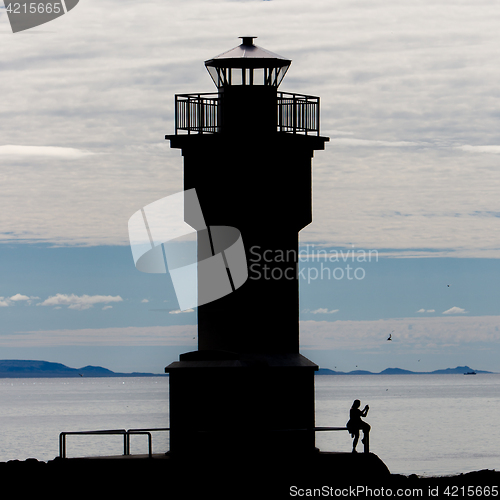 Image of Seascape at sunset with a lighthouse