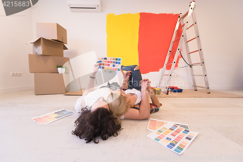 Image of Happy young couple relaxing after painting