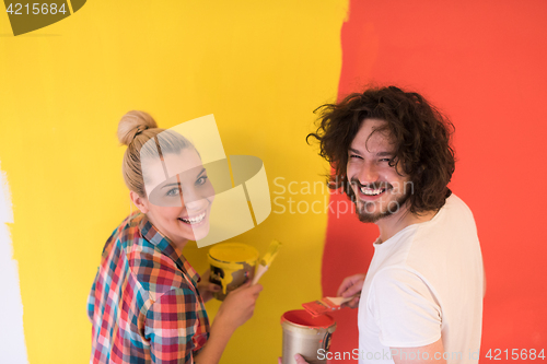 Image of couple painting interior wall