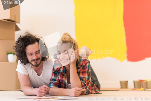 Image of Happy young couple relaxing after painting