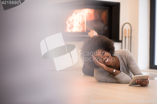 Image of black women using tablet computer on the floor