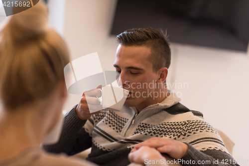 Image of Young couple  in front of fireplace