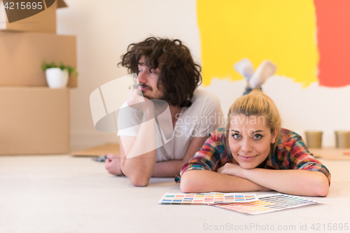 Image of Happy young couple relaxing after painting