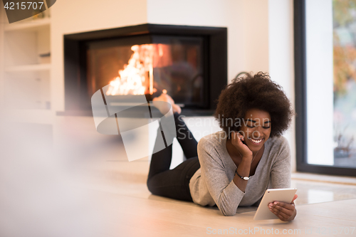 Image of black women using tablet computer on the floor