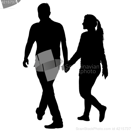 Image of Silhouette man and woman walking hand in hand