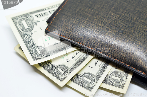 Image of Money sticking out of a leather wallet