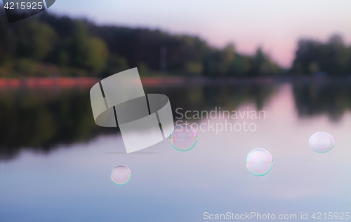 Image of Soap Bubbles Against The Blurred Nature Background