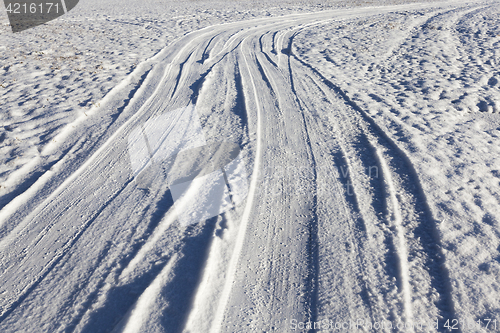 Image of traces of the car on snow