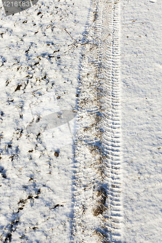 Image of Snow with traces of car