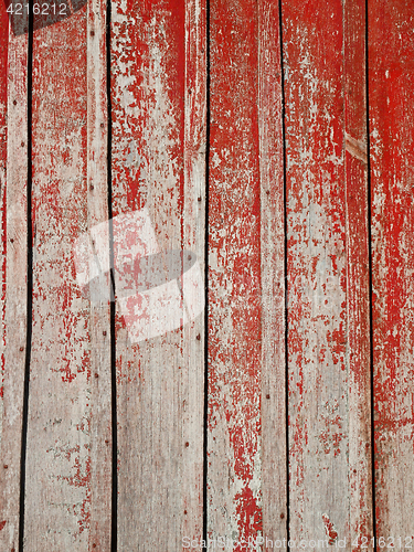 Image of Old wooden planks with shelled red paint