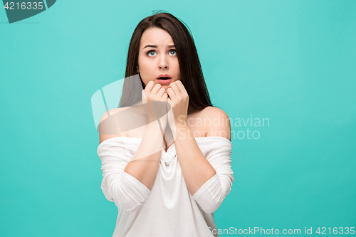 Image of Frustrated young woman posing on blue