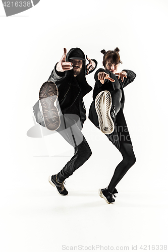 Image of The silhouettes of two hip hop male and female break dancers dancing on white background