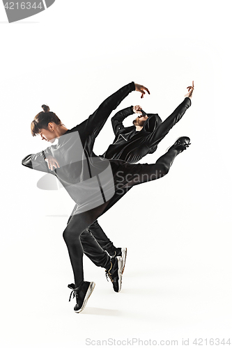 Image of The silhouettes of two hip hop male and female break dancers dancing on white background