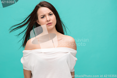 Image of Frustrated young woman posing on blue