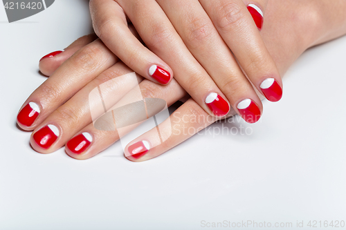 Image of Female hands with red and white nails