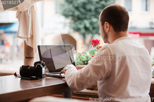 Image of Man is looking at laptop with excitement.