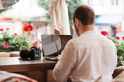 Image of Man is looking at laptop with excitement.