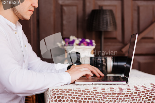 Image of Man is looking at laptop with excitement.