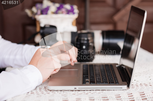 Image of Man is looking at laptop with excitement.