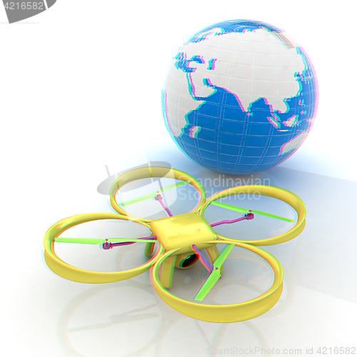 Image of Quadrocopter Drone with Earth Globe and remote controller on a w