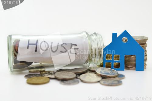 Image of House model and stacks of coins