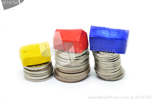 Image of Coins stacked up in piles with color house